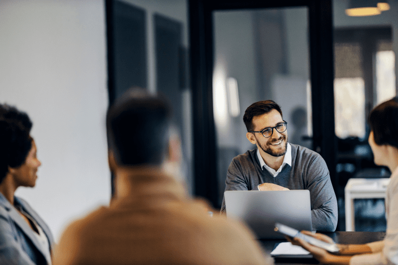 happy businessman is sitting co working space with colleagues having 2 happy businessman is sitting co working space with colleagues having 2